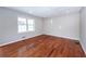 Bright living room featuring gleaming hardwood floors, recessed lighting and large windows at 202 Porter Ln, Jonesboro, GA 30236