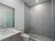 This bathroom features tiled walls and floors, a glass shower enclosure and modern fixtures at 2425 Peachtree Rd # 1806, Atlanta, GA 30305