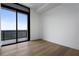 This bedroom has a balcony that offers a view of the surrounding greenery and blue sky at 2425 Peachtree Rd # 1806, Atlanta, GA 30305