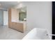 Bright bathroom boasts a soaking tub, modern vanity with light wood cabinets, and large mirror at 2425 Peachtree Rd # 1806, Atlanta, GA 30305