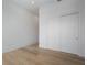 Bright bedroom features hardwood floors, white walls, and sliding closet doors at 2425 Peachtree Rd # 1806, Atlanta, GA 30305