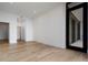 Spacious room featuring light hardwood floors and a walk-in closet with black-framed glass doors at 2425 Peachtree Rd # 1806, Atlanta, GA 30305