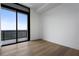 Bright bedroom features hardwood floors, large windows, and access to balcony at 2425 Peachtree Rd # 1806, Atlanta, GA 30305