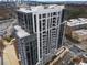 High-rise building with balconies featuring glass railings and outdoor kitchen appliances at 2425 Peachtree Rd # 1806, Atlanta, GA 30305