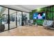 Lounge area with indoor gym access, tv, and accent wall at 2425 Peachtree Rd # 1806, Atlanta, GA 30305