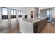 Modern kitchen island with stainless appliances, wine cooler, and living space at 2425 Peachtree Rd # 1806, Atlanta, GA 30305