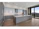 Sleek kitchen with modern appliances, quartz countertops, and large island with a city view at 2425 Peachtree Rd # 1806, Atlanta, GA 30305