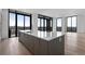 Bright modern kitchen features quartz countertops, gray cabinetry, and an oversized island with great city views at 2425 Peachtree Rd # 1806, Atlanta, GA 30305
