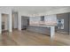 Modern kitchen with a large island, stainless steel appliances, and gray cabinetry at 2425 Peachtree Rd # 1806, Atlanta, GA 30305