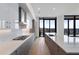 Modern kitchen with gray lower and white upper cabinets, stainless appliances, quartz countertops, and light wood floors at 2425 Peachtree Rd # 1806, Atlanta, GA 30305