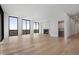 Open-concept living room with hardwood floors, large windows and fireplace at 2425 Peachtree Rd # 1806, Atlanta, GA 30305