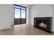 Cozy living room boasts a fireplace, hardwood floors, and a large window showcasing scenic views at 2425 Peachtree Rd # 1806, Atlanta, GA 30305