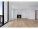 Modern living room featuring a fireplace and floor-to-ceiling windows with a city view at 2425 Peachtree Rd # 1806, Atlanta, GA 30305