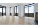 Spacious living room filled with natural light from large windows and hardwood floors at 2425 Peachtree Rd # 1806, Atlanta, GA 30305