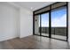 Modern living room with hardwood floors and large glass doors leading to an outdoor balcony at 2425 Peachtree Rd # 1806, Atlanta, GA 30305