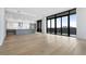 Spacious living area with hardwood floors, expansive windows, and a modern kitchen at 2425 Peachtree Rd # 1806, Atlanta, GA 30305