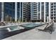 Modern pool deck with lounge chairs and hot tub alongside the pool at 2425 Peachtree Rd # 1806, Atlanta, GA 30305