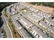 Aerial view of a residential community featuring townhomes, a pool, a playground, and green spaces at 414 Montclair Ct, Woodstock, GA 30188