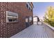 Backyard deck with brick house exterior and view of neighboring houses at 414 Montclair Ct, Woodstock, GA 30188