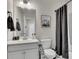 Bathroom features a single sink vanity, toilet, and shower with gray tile at 414 Montclair Ct, Woodstock, GA 30188