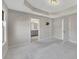 Large primary bedroom featuring neutral walls, carpet, a tray ceiling, and an en suite bathroom at 414 Montclair Ct, Woodstock, GA 30188