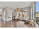 Bright breakfast nook features hardwood floors, neutral walls, large windows, and wicker-style furniture at 414 Montclair Ct, Woodstock, GA 30188