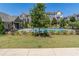 A view of the community pool area, featuring lush green lawns and surrounding townhomes at 414 Montclair Ct, Woodstock, GA 30188