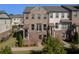 Charming brick townhome showcasing a covered entry, balcony, and lush landscaping at 414 Montclair Ct, Woodstock, GA 30188