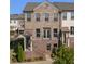 Charming brick townhome featuring a covered entry, and wrought iron railings at 414 Montclair Ct, Woodstock, GA 30188