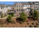 Brick townhome in a community with mature landscaping and well-manicured lawns at 414 Montclair Ct, Woodstock, GA 30188