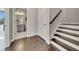 Open hallway featuring hardwood floors, a staircase with white risers, and a bathroom at 414 Montclair Ct, Woodstock, GA 30188