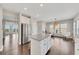 Kitchen with granite-topped island, stainless steel refrigerator, and eat-in breakfast nook area with natural light at 414 Montclair Ct, Woodstock, GA 30188