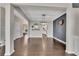 View of the living room with hardwood floors, a decorative shelf, and stylish lighting fixtures at 414 Montclair Ct, Woodstock, GA 30188