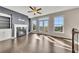 Bright living room featuring hardwood floors, a fireplace, and French doors to the balcony at 414 Montclair Ct, Woodstock, GA 30188