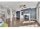 Open-concept living room featuring hardwood floors, a fireplace, and ample natural light at 414 Montclair Ct, Woodstock, GA 30188