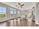 Bright, open-plan living area featuring hardwood floors, ceiling fan, and large windows for natural light at 414 Montclair Ct, Woodstock, GA 30188