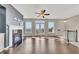 Living room with fireplace, hardwood floors, ceiling fan and doors to balcony at 414 Montclair Ct, Woodstock, GA 30188