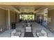 View of the covered patio at the pool house with ceiling fans, lounge seating, and tables at 414 Montclair Ct, Woodstock, GA 30188