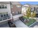 Rear view of townhomes featuring garage, balcony, lawn, and backyard landscaping at 414 Montclair Ct, Woodstock, GA 30188