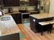 Well-equipped kitchen featuring granite countertops, stainless steel appliances, and dark wood cabinetry at 1101 Senator Rd, Douglasville, GA 30134