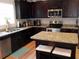 Well-equipped kitchen featuring granite countertops, stainless steel appliances, and dark wood cabinetry at 1101 Senator Rd, Douglasville, GA 30134