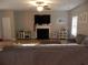 Cozy living room with a fireplace, wood floors, and a comfortable sectional sofa at 1101 Senator Rd, Douglasville, GA 30134