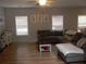 Cozy living room with a fireplace, wood floors, and a comfortable sectional sofa at 1101 Senator Rd, Douglasville, GA 30134