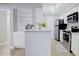 Well-lit kitchen featuring white cabinets, stainless steel appliances, and marble countertops and backsplash at 24317 Plantation Ne Dr, Atlanta, GA 30324