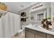 Bathroom with dark wood accents, a mirror, and decorative plants at 122 Lakepointe Court Ct, Stockbridge, GA 30281