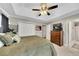 This bedroom features a ceiling fan, closet, and an ensuite bathroom at 122 Lakepointe Court Ct, Stockbridge, GA 30281