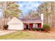 Quaint single-level house with a well-kept front yard, garage, and cozy porch at 122 Lakepointe Court Ct, Stockbridge, GA 30281