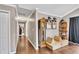 Inviting hallway with wood floors, an antique clock, and decorative artwork at 122 Lakepointe Court Ct, Stockbridge, GA 30281