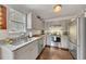 An updated kitchen with stainless steel appliances, granite countertops and hardwood floors at 122 Lakepointe Court Ct, Stockbridge, GA 30281