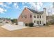 Back exterior featuring a two-story home with brick and siding, a spacious backyard, and attached garage at 190 Holcomb Ct, Fayetteville, GA 30215